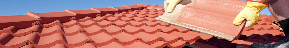worker repairing a cement tiled roof